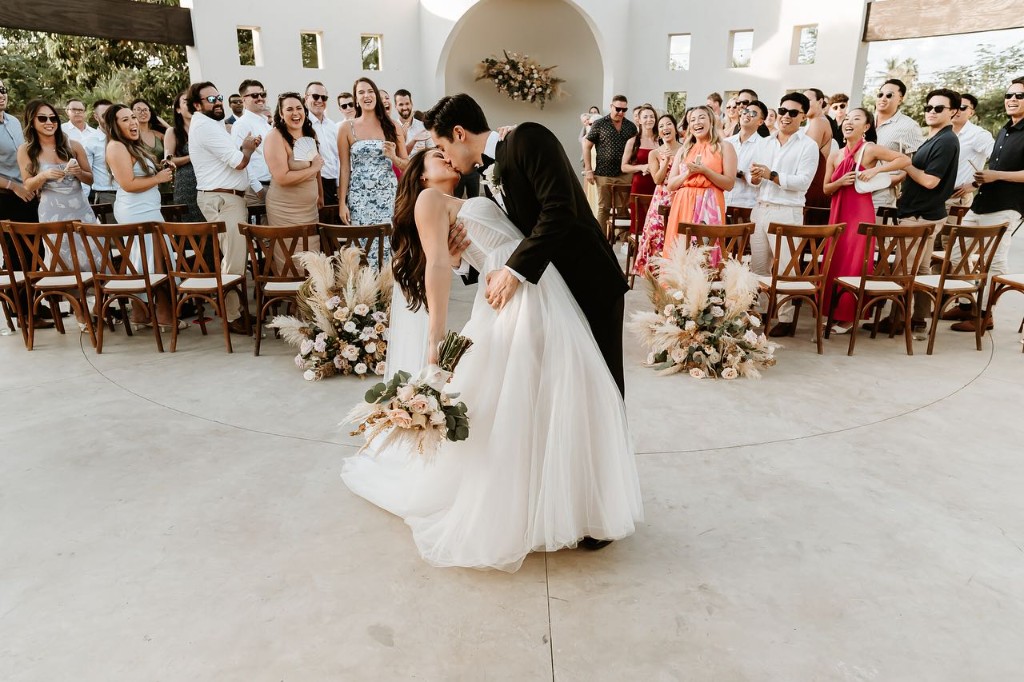 Wedding ceremony recessional with cheering guests